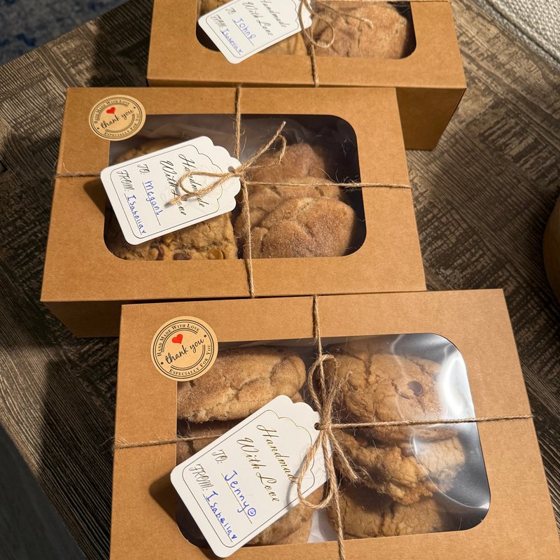 Three tied cookie boxes lined up and ready for delivery